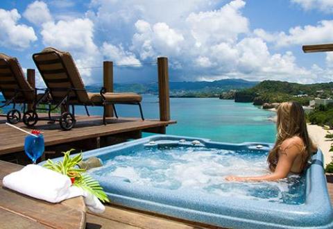 Luxurious hot tub on deck with coastal view, perfect for relaxation and enjoyment