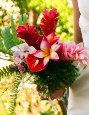 Bride holding colorful tropical bridal bouquet outdoor