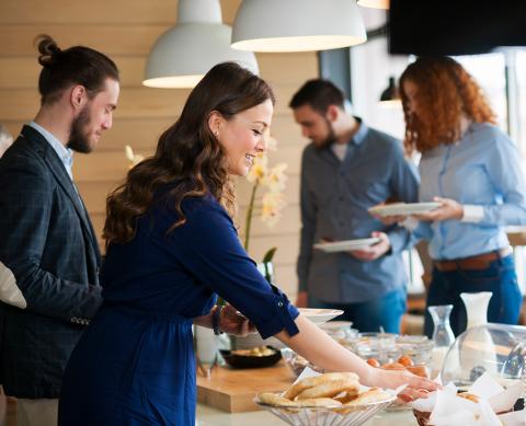 Group enjoying a buffet in a modern dining area at a casual event.