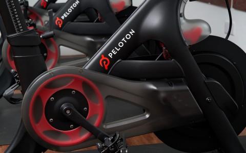 Peloton exercise bike close-up with logo in showroom setting