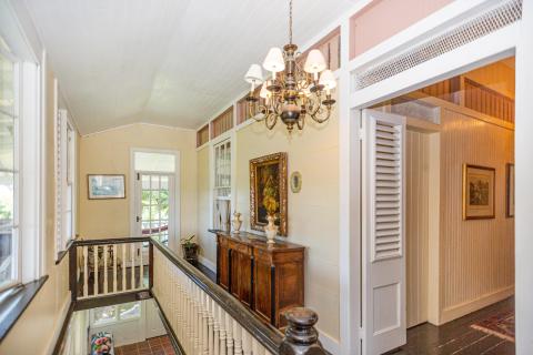 Traditional house interior with vintage chandelier and classic wooden furniture.
