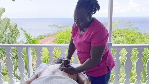Outdoor massage therapy session with sea view on tranquil balcony.