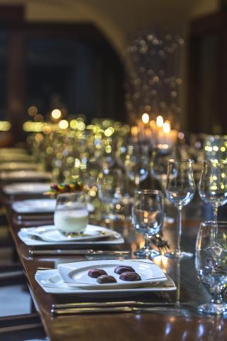 Elegant dining table setup with chocolate candies and creamy beverage, cozy ambiance.