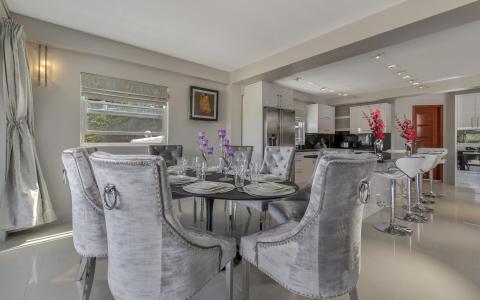 Modern dining and kitchen area with stylish decor and natural lighting