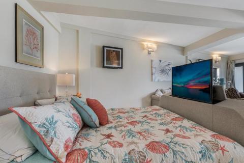 Cozy bedroom with nature-themed decor, floral bedding, and framed artwork