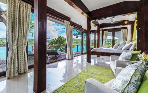 Elegant room with scenic view, hardwood floors, and modern decor overlooking nature.