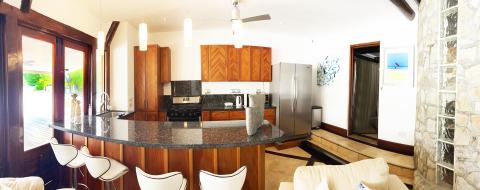 Modern kitchen with wooden cabinets, granite counters, and stainless appliances.