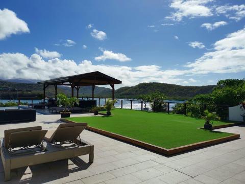 Luxurious outdoor terrace with modern furniture overlooking a scenic lake.