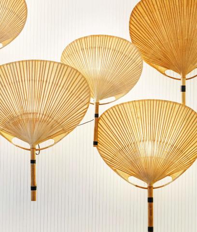 The image shows a series of decorative pendant lights shaped like large hand fans