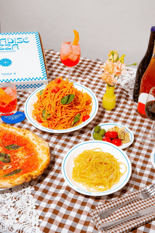 The image features a vibrant and appetizing table setting focused on Italian cuisine