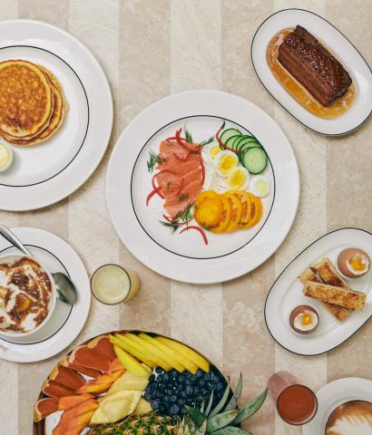 This image showcases an array of beautifully presented dishes on a marble-topped table:

1