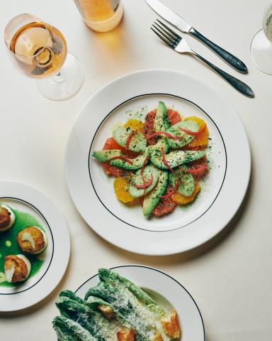 The image displays a well-presented table with a variety of gourmet dishes, including:

1