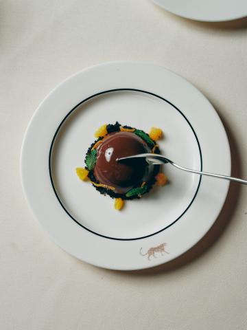 This is an image of a sophisticated dessert presentation on a white plate