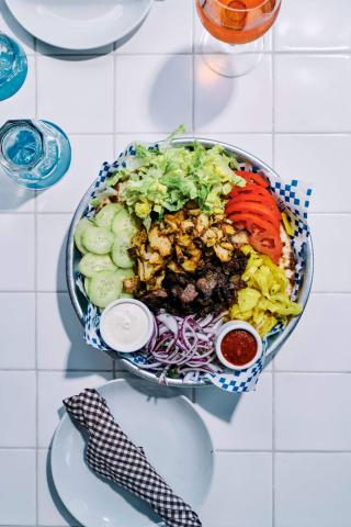 This image features a vibrant and colorful plate of food, arranged beautifully on a tiled table