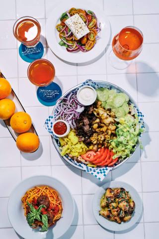 This image displays a vibrant and appetizing array of dishes on a tiled table