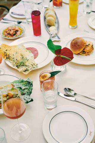 The image showcases a beautifully arranged table setting with a variety of foods and beverages