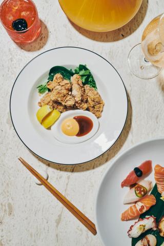 The image features an elegantly arranged selection of food and drinks