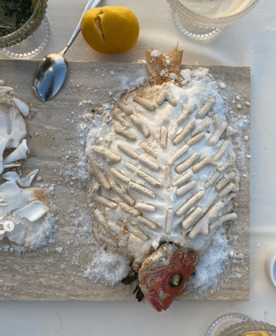 This image shows a fish that has been prepared and served with a decorative, artistic presentation