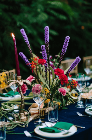 The image shows an elegantly set dining table for a special event, possibly a wedding or formal dinner
