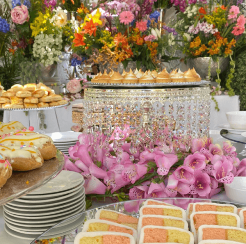 This image showcases a beautifully arranged dessert table at what appears to be a festive or celebratory event