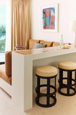 The image features a modern, well-lit indoor space which appears to be a part of a living room or lounge area