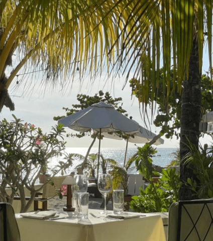 This image shows a serene beachside dining setup