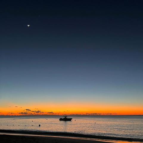 This image features a serene sunset at the beach