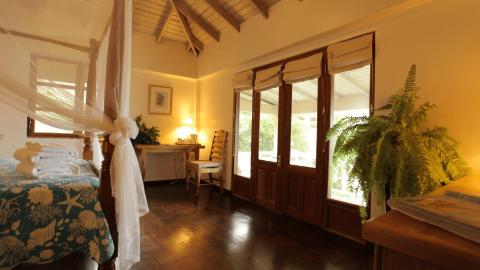 Cozy tropical bedroom with a four-poster bed and marine-themed decor