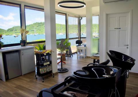 Modern hair salon interior with yacht bay view, shampoo stations, and styling area.