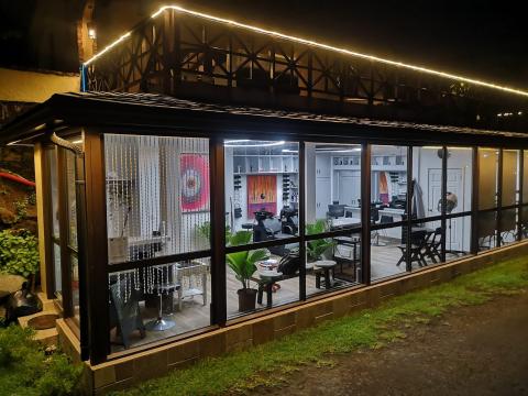 Modern hair salon interior with stylish decor and large windows at night