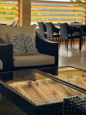 Coastal cafe interior with wicker furniture and soft lighting