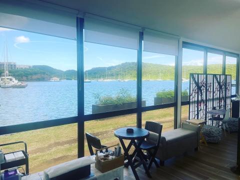 Cozy indoor space with modern furniture overlooking a serene coastal view.