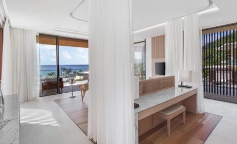 Modern indoor space with contemporary furniture and sea view patio.