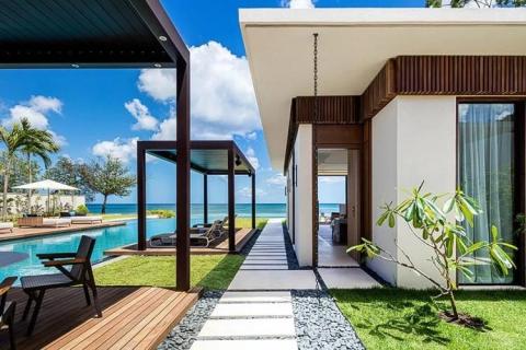 Luxury beachfront villa with pool, deck, and ocean view, ideal for relaxation and leisure