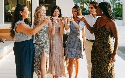 Group of friends toasting on a sunny patio, in a joyful, relaxed setting