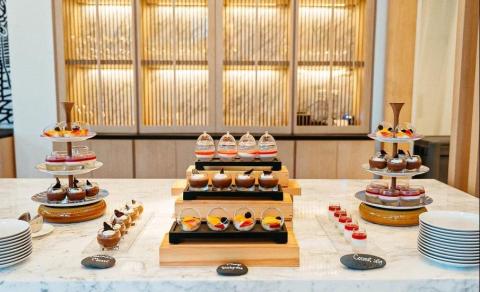 Elegant dessert station with variety of gourmet treats in modern venue