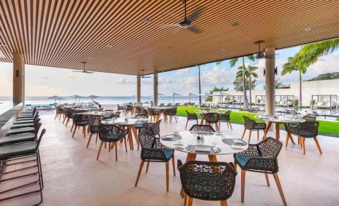 Elegant beachfront dining terrace at a tropical resort with sea views