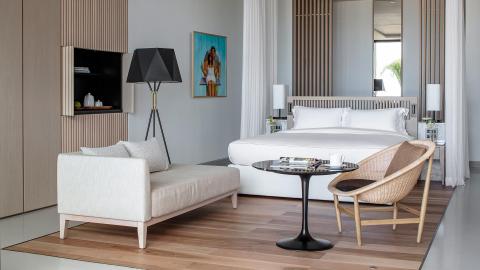 Stylish modern bedroom with round bed, wooden accents, and serene decor.