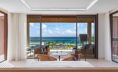 Stylish hotel room with sea view, balcony, and modern decor