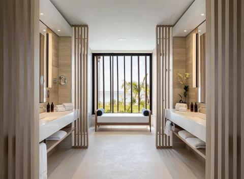 Luxurious modern bathroom with double vanity and tropical view