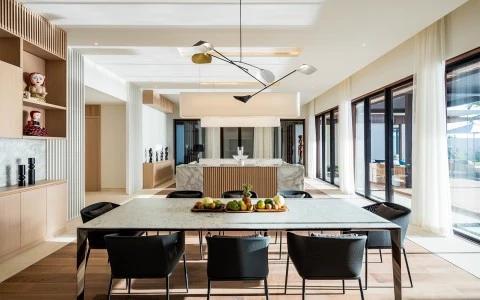 Modern kitchen and dining area with marble elements and sleek design