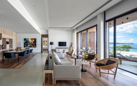 Luxurious living room with beach view, modern furniture, and abstract art.