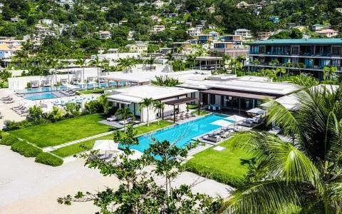 Luxurious resort with pools and lush greenery in a tropical hillside setting