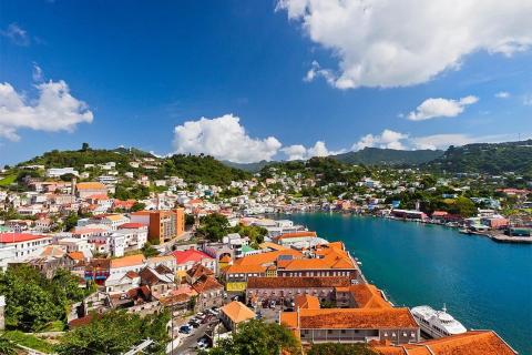 Colorful coastal town with hillside buildings and a blue harbor