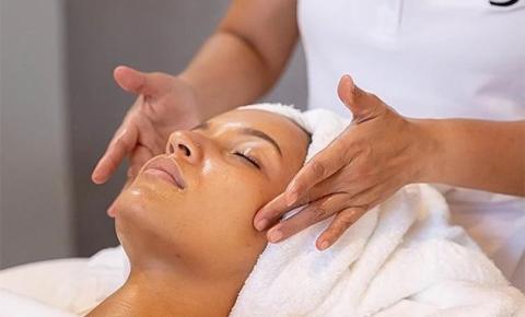 Relaxed woman getting facial treatment at a serene spa.