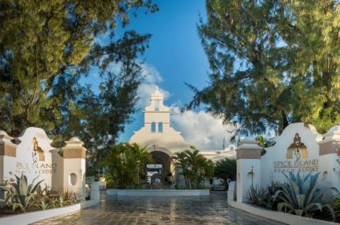 Entrance of Spice Island Beach Resort with grand archway and lush greenery.