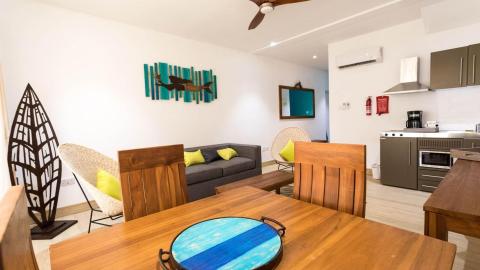 Modern apartment interior with nautical theme and cozy furnishings.