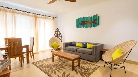 Stylish living room with modern decor, connected to a cozy dining area
