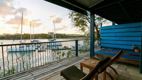Tranquil balcony view of marina with sailboats and sunset
