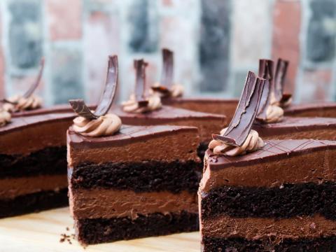 Decadent multi-layer chocolate cake slices with creamy filling and elegant toppings.
